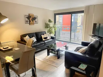 a living room with a couch and a table at City Centre 2BR Apartment, Free Parking! in Liverpool