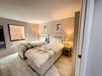 a bedroom with two beds and a window at City Centre 2BR Apartment, Free Parking! in Liverpool
