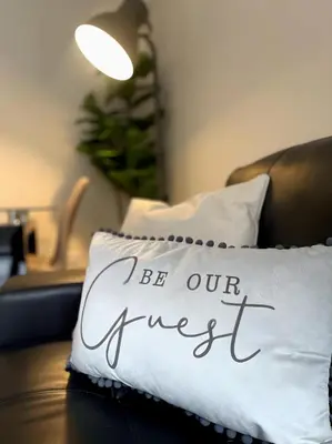 a pillow with the words be our guest written on it at City Centre 2BR Apartment, Free Parking! in Liverpool