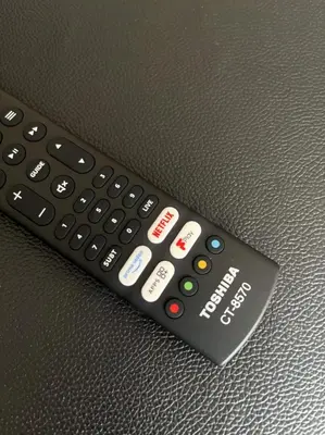 a remote control sitting on top of a couch at City Centre 2BR Apartment, Free Parking! in Liverpool
