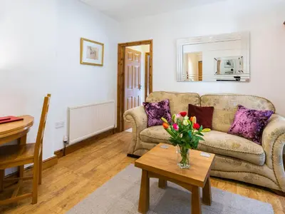 a living room with a couch and a table at Wolfen Mill in Preston
