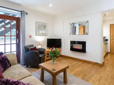 a living room with a couch and a table at Wolfen Mill in Preston