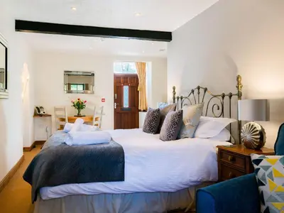 a bedroom with a large bed and a blue chair at Wolfen Mill in Preston