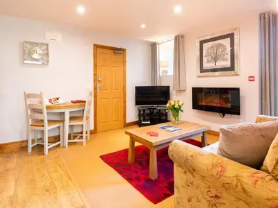 a living room with a couch and a table at Wolfen Mill in Preston
