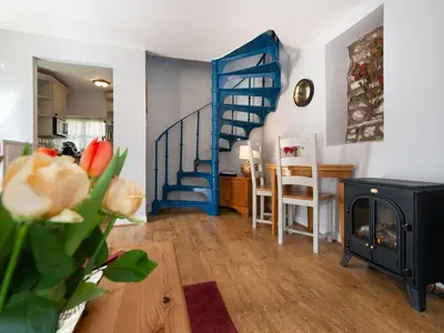 a living room with a blue staircase and a table at Wolfen Mill in Preston