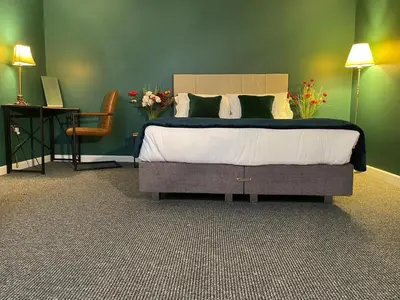 a bedroom with a bed and a table and a chair at Three-Bedroom Superior Apartment - Sleeps 6 in Southport