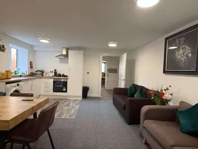 a living room with a couch and a table at Three-Bedroom Superior Apartment - Sleeps 6 in Southport