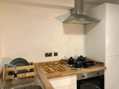 a kitchen with a stove with pots and pans on it at Three-Bedroom Superior Apartment - Sleeps 6 in Southport