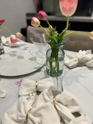 a table with a glass vase with flowers in it at Amazing 10 bed apartments on Mathew Street in Liverpool