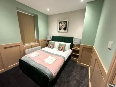 a bedroom with a large bed in a room at Full Private House Sleeping 26 in Blackpool