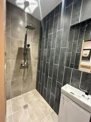 a bathroom with a shower with a toilet and a sink at Full Private House Sleeping 26 in Blackpool
