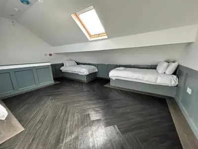 a room with two beds and a window on the wall at Full Private House Sleeping 26 in Blackpool