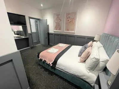 a bedroom with a bed and a television in it at Full Private House Sleeping 26 in Blackpool