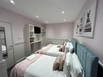 a bedroom with two beds with pillows at Full Private House Sleeping 26 in Blackpool