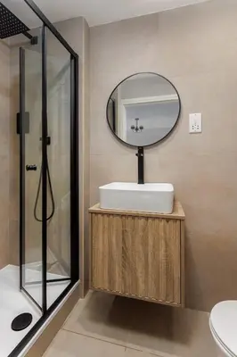 a bathroom with a sink and a mirror at Flatzy - Prime City Apartment with Free Parking & Ping Pong Table in Liverpool
