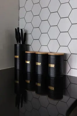 a row of black plates and utensils on a counter at Flatzy - Prime City Apartment with Free Parking & Ping Pong Table in Liverpool