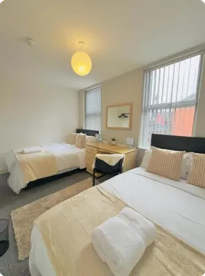a bedroom with two beds and a desk and window at Room 4 Shared House in L6 in Liverpool