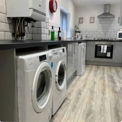 a kitchen with a washer and dryer in it at Room 4 Shared House in L6 in Liverpool