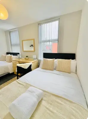 a large bedroom with two beds and a desk at Room 4 Shared House in L6 in Liverpool