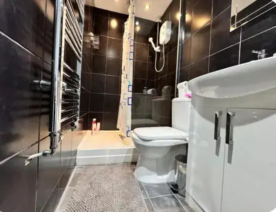 a bathroom with a toilet and a shower and a sink at Room 4 Shared House in L6 in Liverpool