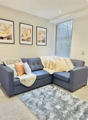 a blue couch sitting in a living room at Room 4 Shared House in L6 in Liverpool