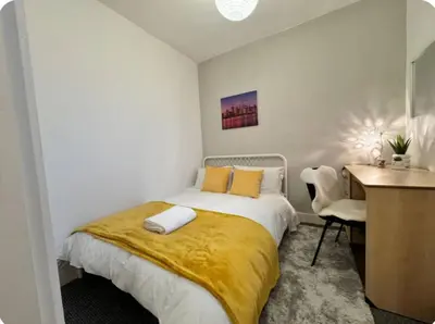 a bedroom with a bed with a desk and a chair at Room 5 Shared House in L6 in Liverpool