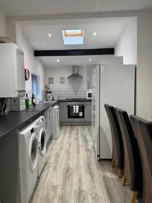 a kitchen with a washer and dryer in it at Room 5 Shared House in L6 in Liverpool