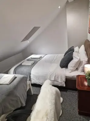 a bedroom with two beds and a couch at Room 6 Shared House in L6 in Liverpool