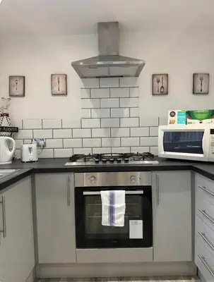 a kitchen with a stove and a microwave at Room 6 Shared House in L6 in Liverpool
