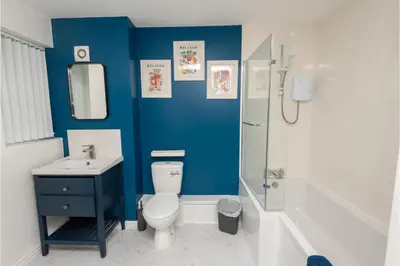 a bathroom with a toilet and a sink and a shower at Central 3 Bedroom Flat w Parking in Liverpool