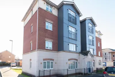 a tall building with a red brick at Central 3 Bedroom Flat w Parking in Liverpool