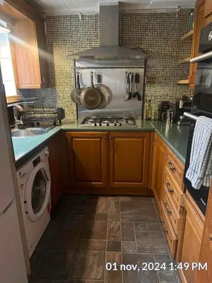 a kitchen with a stove and a washing machine at Home in Liverpool in Liverpool