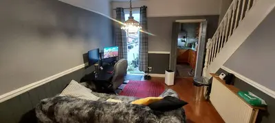 a living room with a couch and a tv at Home in Liverpool in Liverpool