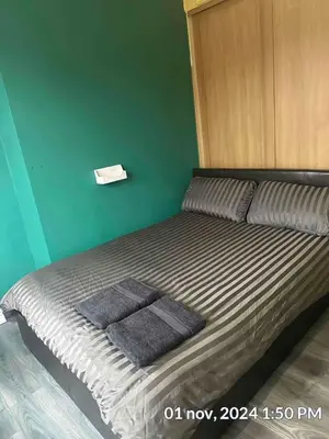 a bed with two towels on it in a room at Home in Liverpool in Liverpool