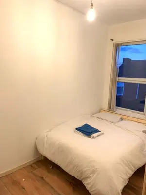 a small bedroom with a bed and a window at Home in Liverpool in Liverpool