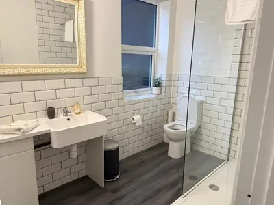 a white bathroom with a sink and a toilet at 61 Moorfields city centre apartment sleeps 10 in Liverpool