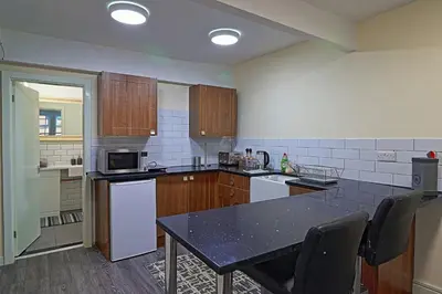 a kitchen with a table and a counter top at 61 Moorfields city centre apartment sleeps 10 in Liverpool