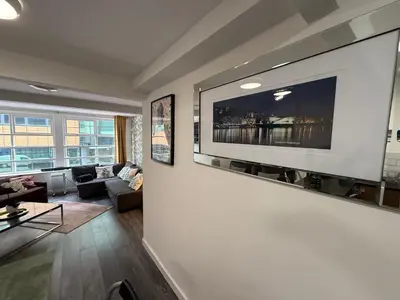 a living room with a large flat screen tv on a wall at 61 Moorfields city centre apartment sleeps 10 in Liverpool