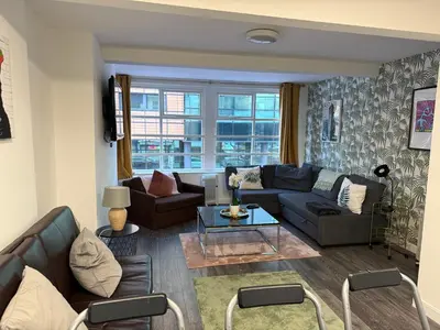 a living room with a couch and a table at 61 Moorfields city centre apartment sleeps 10 in Liverpool