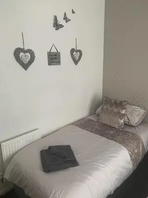 a bedroom with a bed with hearts on the wall at The Butterfly Hotel in Blackpool