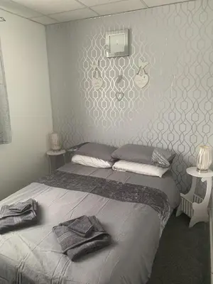 a bedroom with a bed with two towels on it at The Butterfly Hotel in Blackpool