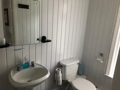 a bathroom with a sink and a toilet and a mirror at The Butterfly Hotel in Blackpool