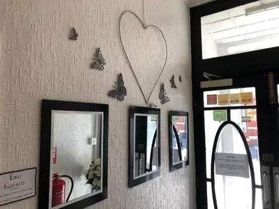 a wall with mirrors and butterflies on it at The Butterfly Hotel in Blackpool