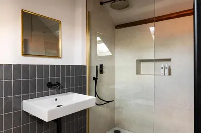 a bathroom with a sink and a shower at Domain Boutique Rooms in Lancaster