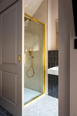 a bathroom with a shower with a glass door at Domain Boutique Rooms in Lancaster
