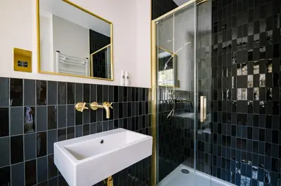 a bathroom with a sink and a mirror at Domain Boutique Rooms in Lancaster