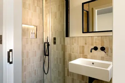 a bathroom with a sink and a mirror at Domain Boutique Rooms in Lancaster