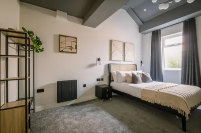 a bedroom with a bed and a window at Domain Boutique Rooms in Lancaster