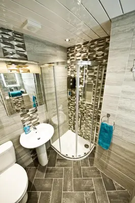 a bathroom with a shower and a toilet and a sink at Rossall Guest House Blackpool - Ideal For Families & Couples in Blackpool