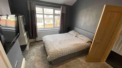 a small bedroom with a bed and a window at Lux nights away in Cleveleys